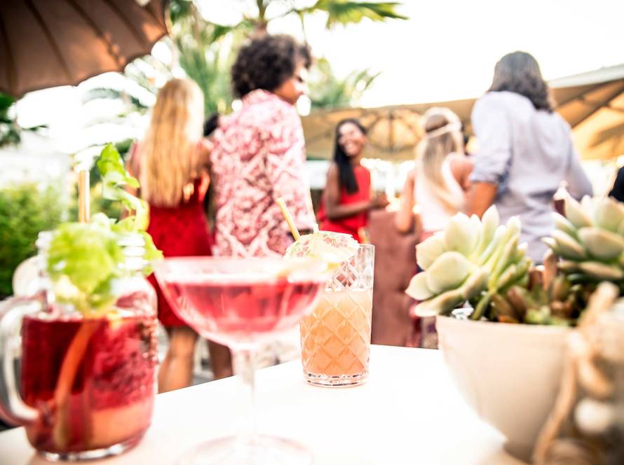 Professional bartender pouring a handcrafted cocktail from a mobile bar at a private event in NYC.